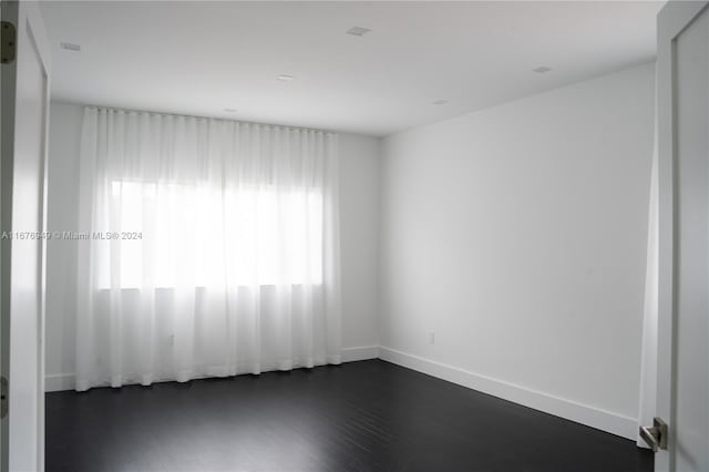 empty room with dark hardwood / wood-style floors