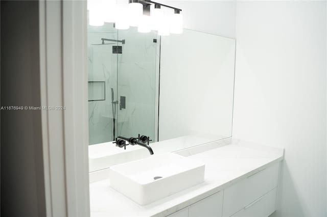 bathroom featuring vanity and a shower with shower door