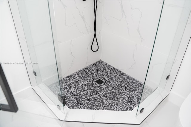 bathroom with tiled shower