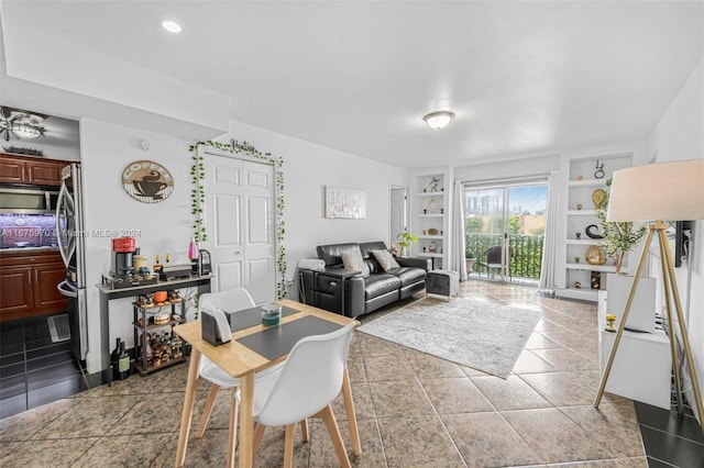 living room with tile patterned floors and built in shelves