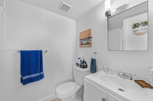 bathroom featuring toilet and vanity