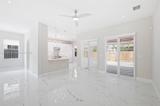 unfurnished room with sink and ceiling fan