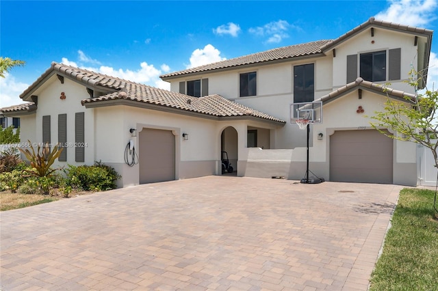 mediterranean / spanish-style home with a garage