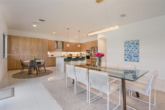 tiled dining room with sink