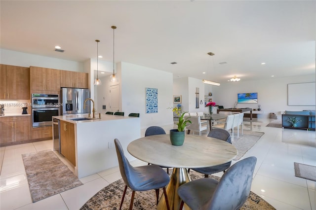 dining room featuring sink and light tile patterned floors