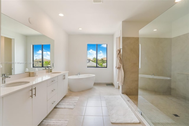 bathroom with vanity, a healthy amount of sunlight, separate shower and tub, and tile patterned flooring