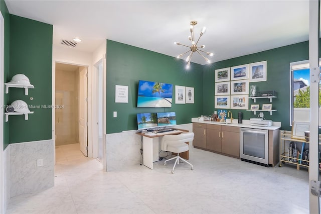 office featuring tile walls, sink, and a chandelier