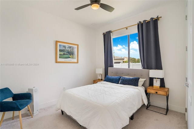 bedroom with ceiling fan and light carpet