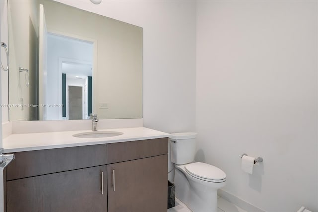 bathroom with vanity, toilet, and tile patterned flooring