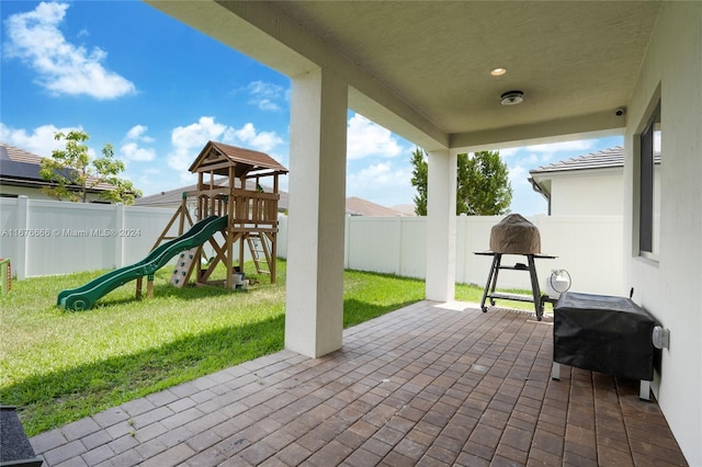 view of patio / terrace with grilling area and a playground