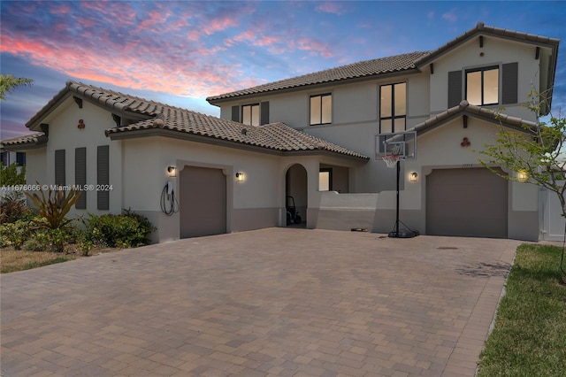 mediterranean / spanish-style home featuring a garage