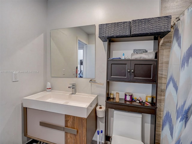 bathroom featuring vanity and toilet