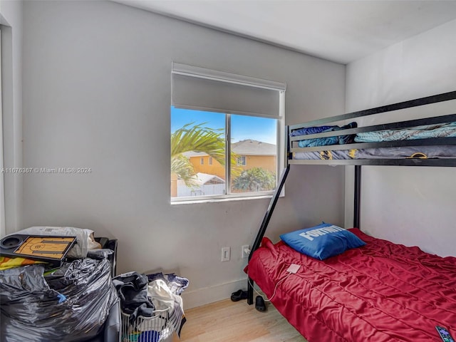 bedroom with hardwood / wood-style flooring