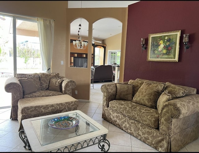 tiled living room featuring an inviting chandelier