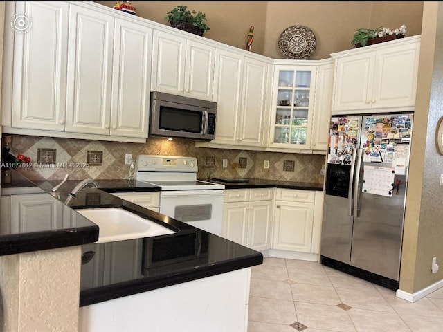 kitchen with white cabinets, sink, appliances with stainless steel finishes, and light tile patterned flooring