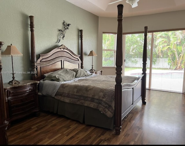 bedroom with access to outside, dark hardwood / wood-style flooring, and multiple windows