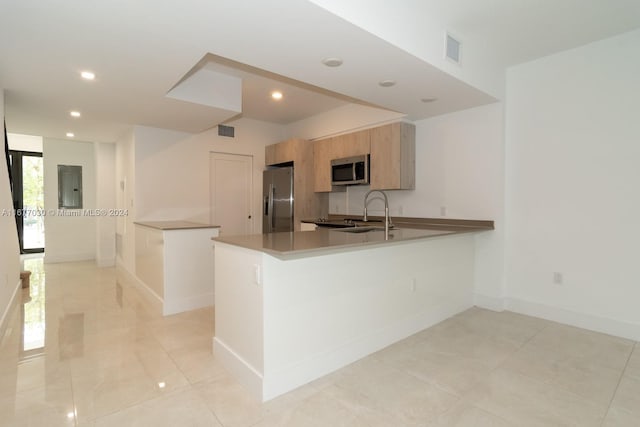 kitchen featuring electric panel, kitchen peninsula, and stainless steel appliances