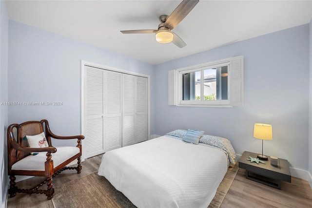 bedroom with ceiling fan, wood-type flooring, and a closet