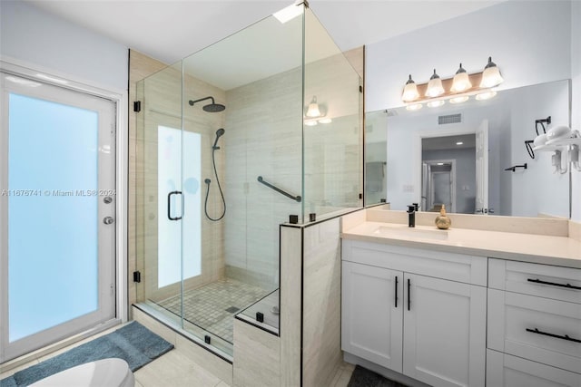 bathroom with vanity and a shower with shower door