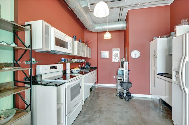 kitchen with white cabinets, white appliances, and pendant lighting