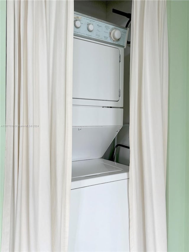 washroom featuring stacked washer and dryer