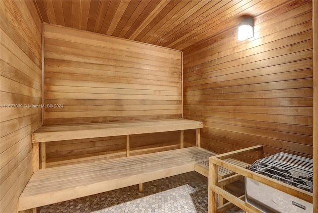 view of sauna featuring wood ceiling and wooden walls