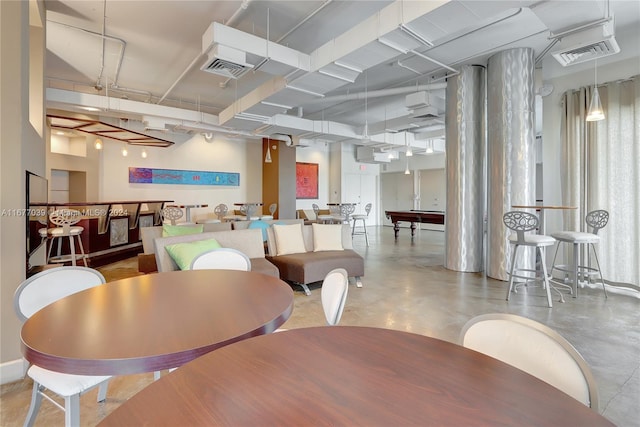 dining area with concrete floors and pool table