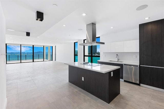 kitchen with dishwasher, a kitchen island, island exhaust hood, light countertops, and white cabinetry