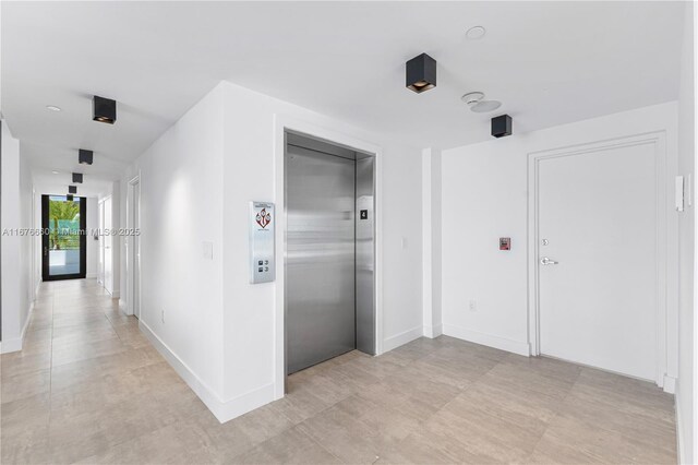 spare room with a wealth of natural light, light hardwood / wood-style floors, and floor to ceiling windows