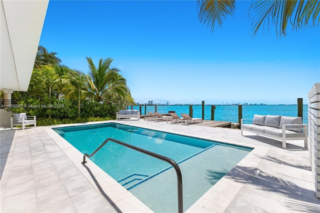 pool featuring a water view, a patio, and outdoor lounge area