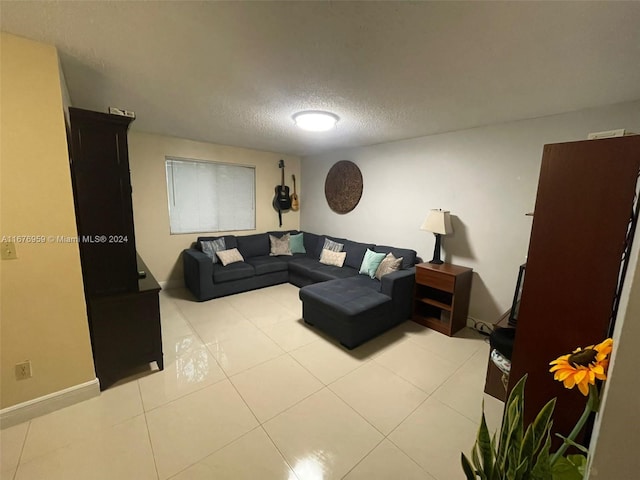 tiled living room featuring a textured ceiling