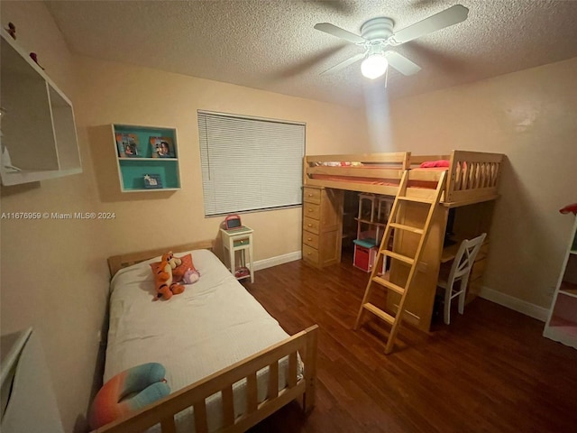 bedroom with a textured ceiling, dark hardwood / wood-style floors, and ceiling fan