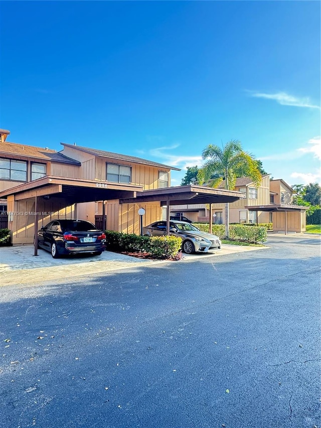 view of vehicle parking with a carport