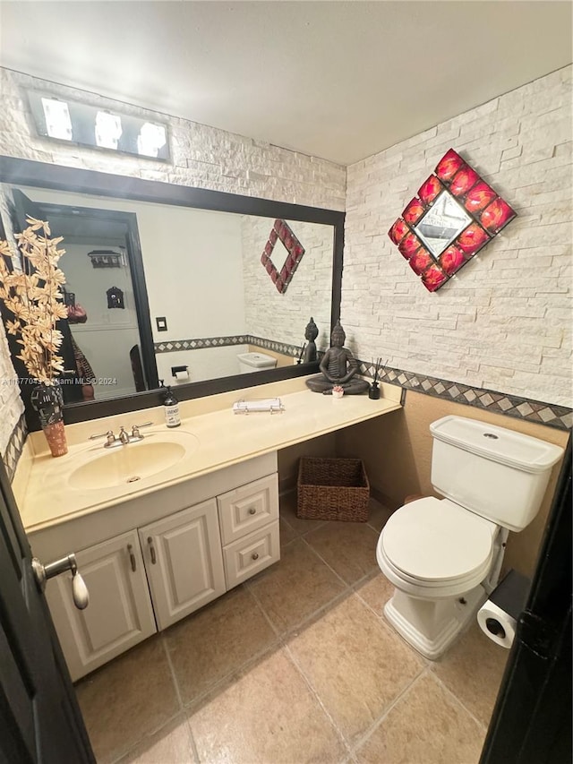 bathroom featuring vanity, toilet, and tile patterned floors