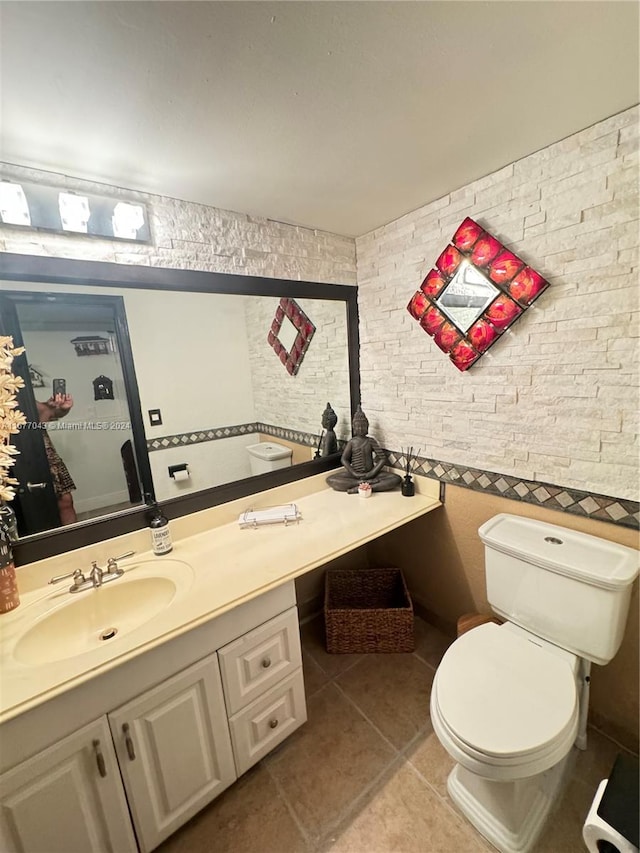 bathroom featuring vanity, toilet, and tile patterned flooring