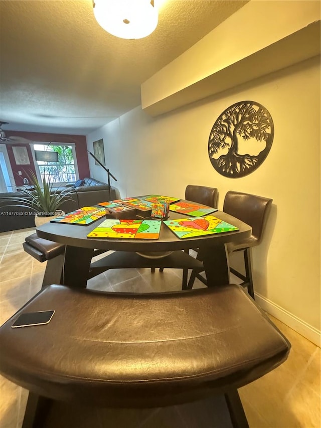 playroom with ceiling fan and a textured ceiling