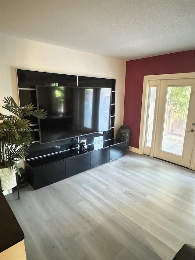 living room with hardwood / wood-style floors and a textured ceiling