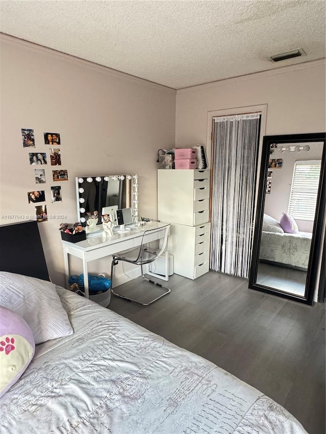 bedroom with a textured ceiling and hardwood / wood-style floors