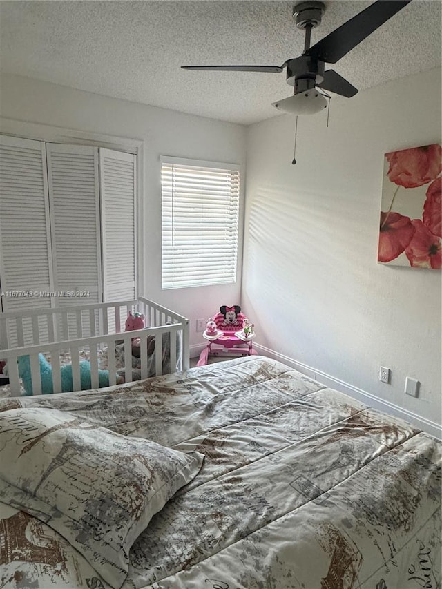 bedroom with a textured ceiling and ceiling fan