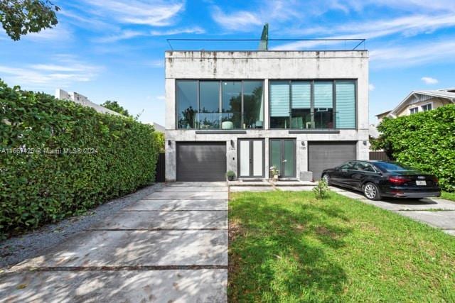 modern home with a front lawn and a garage