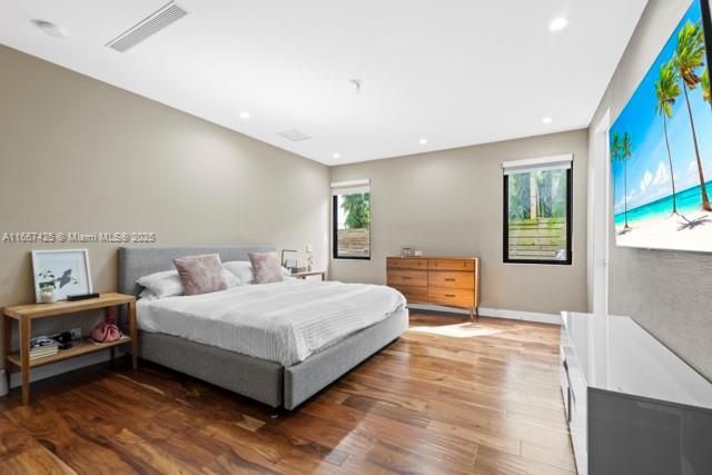 bedroom featuring dark wood-type flooring and multiple windows