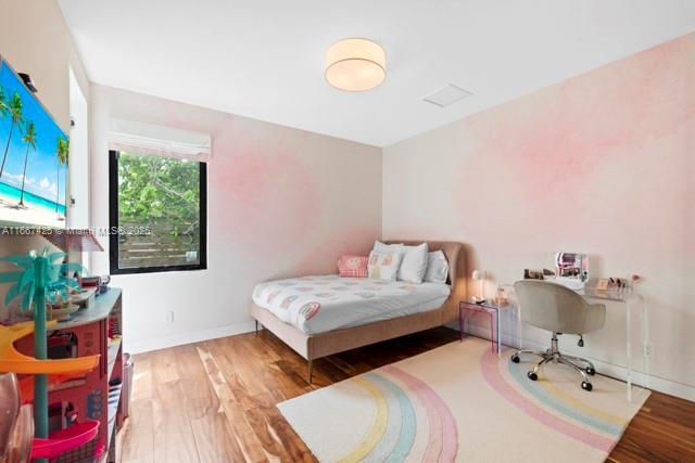 bedroom with dark wood-type flooring and a closet