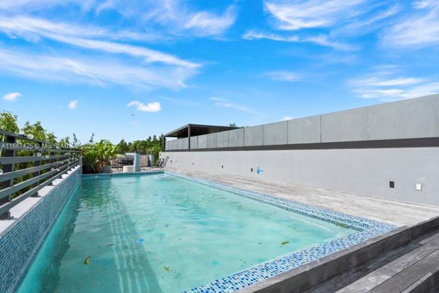 view of swimming pool featuring a wooden deck