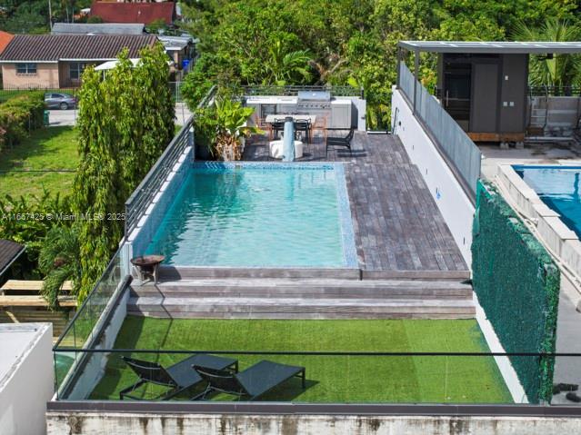 view of swimming pool with a jacuzzi