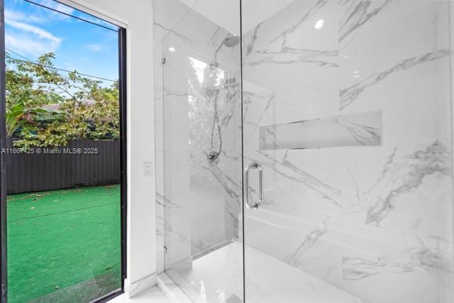 bathroom featuring an enclosed shower