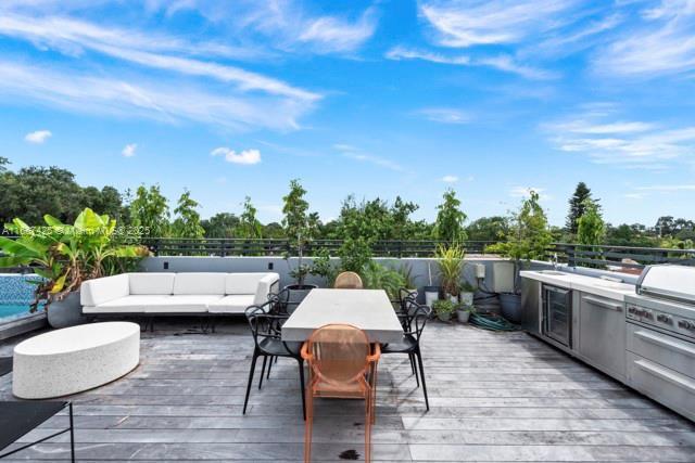 wooden terrace featuring outdoor lounge area