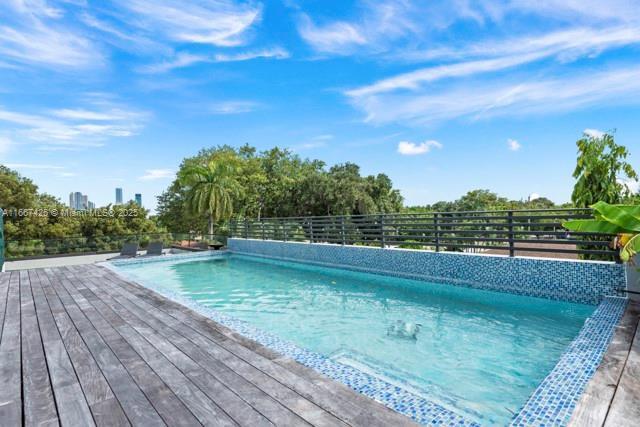 view of swimming pool featuring a deck