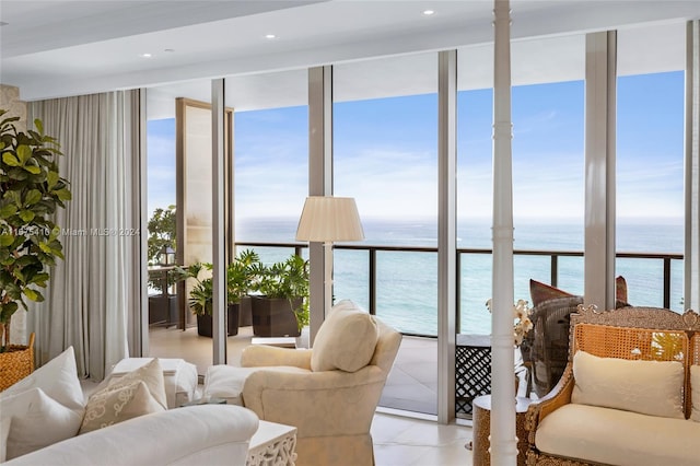 living room featuring a water view and light tile patterned floors