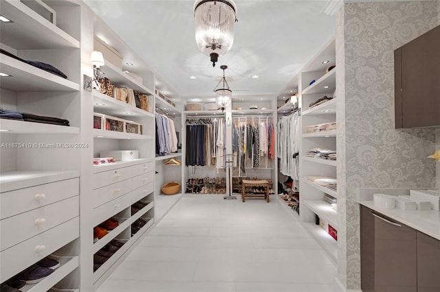 spacious closet featuring a notable chandelier