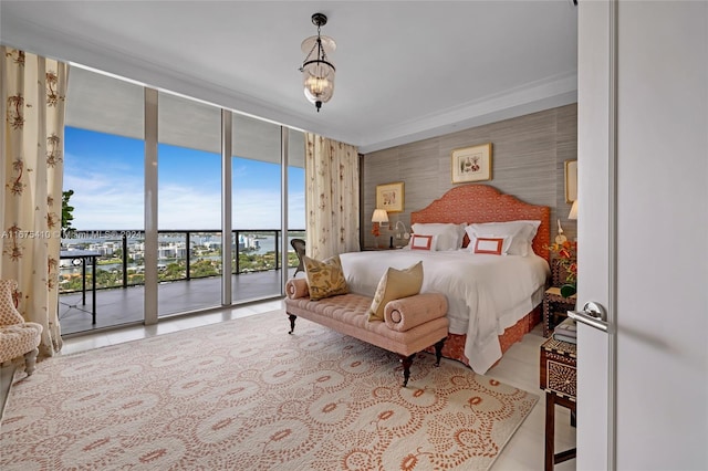 bedroom featuring access to outside, multiple windows, and expansive windows